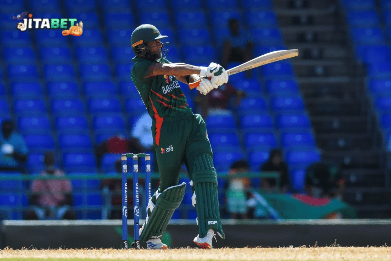 a man in green uniform holding a bat